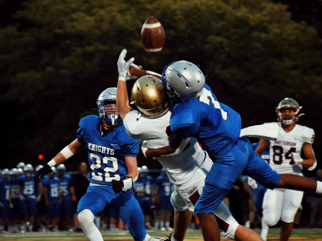 Demonstrating a football injury during a tackle